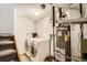 Functional laundry room equipped with a washer, dryer, and a modern water heater for convenience at 12935 W 64Th Dr # D, Arvada, CO 80004
