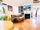 Comfortable living room features a fireplace, wood floors, and a large TV at 12935 W 64Th Dr # D, Arvada, CO 80004