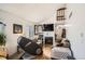 Open living room with fireplace, comfortable seating, and a view of the entryway at 12935 W 64Th Dr # D, Arvada, CO 80004