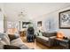 Bright living room featuring hardwood floors, a ceiling fan, and neutral-colored walls at 12935 W 64Th Dr # D, Arvada, CO 80004