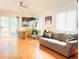 Inviting living room with wood floors, sliding glass door, and plants at 12935 W 64Th Dr # D, Arvada, CO 80004
