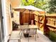 Cozy outdoor patio features a glass-topped table with seating and string lights at 12935 W 64Th Dr # D, Arvada, CO 80004