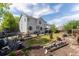Wide backyard view showcasing the patio, lawn, and exterior of the two-story home with ample space for recreation at 4715 E 127Th Dr, Thornton, CO 80241