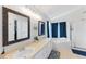 Bright bathroom showcasing double vanity, tub, and shower at 4715 E 127Th Dr, Thornton, CO 80241