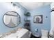 A modern bathroom with stylish blue walls and chic decor at 4715 E 127Th Dr, Thornton, CO 80241