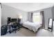 Bedroom featuring neutral walls, window, and computer setup at 4715 E 127Th Dr, Thornton, CO 80241