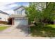 Charming two-story home showcasing a well-manicured front yard and a two car garage at 4715 E 127Th Dr, Thornton, CO 80241
