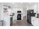Modern kitchen featuring white cabinets, stainless steel appliances, and hardwood floors at 4715 E 127Th Dr, Thornton, CO 80241