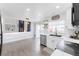Open-concept kitchen and dining area with modern finishes and access to the deck at 4715 E 127Th Dr, Thornton, CO 80241