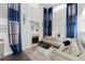 Bright living room featuring fireplace and stylish blue curtains at 4715 E 127Th Dr, Thornton, CO 80241