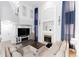 Spacious living room with fireplace, TV, and elegant decor at 4715 E 127Th Dr, Thornton, CO 80241