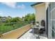 The lovely balcony features a table, and wonderful views of the lush community at 8653 E Dry Creek Rd # 1121, Englewood, CO 80112