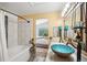 Bright bathroom with a unique vessel sink on marble countertop and decorative fixtures at 8653 E Dry Creek Rd # 1121, Englewood, CO 80112