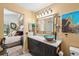 Stylish bathroom with a unique vessel sink, elegant vanity, and decorative lighting at 8653 E Dry Creek Rd # 1121, Englewood, CO 80112