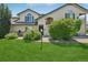 Well-manicured lawn and mature landscaping add to the curb appeal of this home at 8653 E Dry Creek Rd # 1121, Englewood, CO 80112