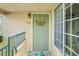 Charming front door with floral wreath, cheerful rug, and sage-green paint at 8653 E Dry Creek Rd # 1121, Englewood, CO 80112