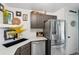Bright kitchen featuring stainless steel appliances, dark cabinets, and white countertops at 8653 E Dry Creek Rd # 1121, Englewood, CO 80112