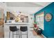 Open kitchen area with a breakfast bar, modern appliances, and open access to the living area at 8653 E Dry Creek Rd # 1121, Englewood, CO 80112