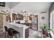 Well-lit kitchen with stainless steel appliances, gray cabinets, breakfast bar, and modern finishes at 8653 E Dry Creek Rd # 1121, Englewood, CO 80112