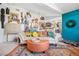 Bright living room featuring sofa, ottoman, and vibrant decor with view of the kitchen at 8653 E Dry Creek Rd # 1121, Englewood, CO 80112