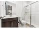 Contemporary bathroom with white tile shower and glass doors, complemented by a modern dark vanity at 303 Rogers Ct, Castle Rock, CO 80104