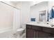 Bright bathroom with modern vanity, tub-shower combo with white tiled walls, and tile floor at 303 Rogers Ct, Castle Rock, CO 80104