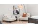 Comfortable bedroom showcases two armchairs and an elegant floor lamp with decor at 303 Rogers Ct, Castle Rock, CO 80104