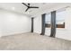 Large bedroom with plush carpeting, ceiling fan, and big windows with mountain views at 303 Rogers Ct, Castle Rock, CO 80104