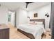 Bright bedroom with modern decor and a wood-look floor leading to an open doorway at 303 Rogers Ct, Castle Rock, CO 80104