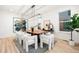 Bright dining room boasts a wood table, stylish chairs, modern lighting, and an abstract painting at 303 Rogers Ct, Castle Rock, CO 80104
