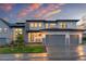 Modern home featuring a three-car garage, stone accents, and covered front porch at 303 Rogers Ct, Castle Rock, CO 80104
