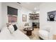 Bright flex room featuring modern furniture, floating shelves, and a dark window shade at 303 Rogers Ct, Castle Rock, CO 80104