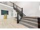 Bright entryway features a staircase with iron railings and wood accents at 303 Rogers Ct, Castle Rock, CO 80104