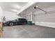 Spacious garage with epoxy flooring, vehicle, and ample storage space at 303 Rogers Ct, Castle Rock, CO 80104