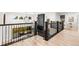 Second floor with open staircase, modern railing, and views of the lower level with floor-to-ceiling fireplace at 303 Rogers Ct, Castle Rock, CO 80104