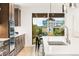 Modern kitchen featuring a large island with white countertops, stainless steel appliances, and dark wood cabinets at 303 Rogers Ct, Castle Rock, CO 80104