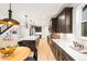 Modern kitchen with island featuring white countertops, stainless steel appliances, and dark wood cabinets at 303 Rogers Ct, Castle Rock, CO 80104