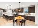 Well-designed kitchen features a large island, modern appliances, pendant lighting, dark wood cabinets and breakfast nook at 303 Rogers Ct, Castle Rock, CO 80104
