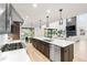 Open concept kitchen with a large island, stainless steel appliances, and views of the living room at 303 Rogers Ct, Castle Rock, CO 80104
