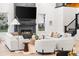 Bright living room with a modern fireplace and flat screen, surrounded by cozy white furniture at 303 Rogers Ct, Castle Rock, CO 80104