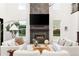 Stunning living room with a modern fireplace, ample natural light, and contemporary decor at 303 Rogers Ct, Castle Rock, CO 80104