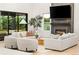 Bright living room features a fireplace, comfortable seating, modern decor, and ample natural light at 303 Rogers Ct, Castle Rock, CO 80104