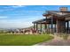 Inviting outdoor patio with dining and seating areas, a covered structure, and a picturesque view of the hillside at 303 Rogers Ct, Castle Rock, CO 80104