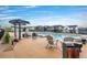 Outdoor pool area with lounge chairs, umbrellas, and a scenic view of the surrounding homes and landscape at 303 Rogers Ct, Castle Rock, CO 80104