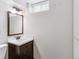 Second bathroom with a vanity, sink, and mirror with overhead lighting at 6769 S Foresthill St, Littleton, CO 80120