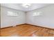 Empty bedroom with hardwood floors and plenty of natural light from two windows at 6769 S Foresthill St, Littleton, CO 80120