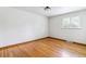 Cozy bedroom featuring hardwood floors and a window overlooking the yard at 6769 S Foresthill St, Littleton, CO 80120