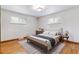 Cozy bedroom features neutral colors, hardwood floors, and a comfy bed at 6769 S Foresthill St, Littleton, CO 80120