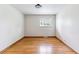 Bright bedroom with hardwood floors and a window providing natural light at 6769 S Foresthill St, Littleton, CO 80120