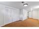 Bedroom features a closet with bi-fold doors and neutral carpeting at 6769 S Foresthill St, Littleton, CO 80120